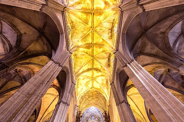 Ribbed Gothic vaults lit in gold inside the cathedral